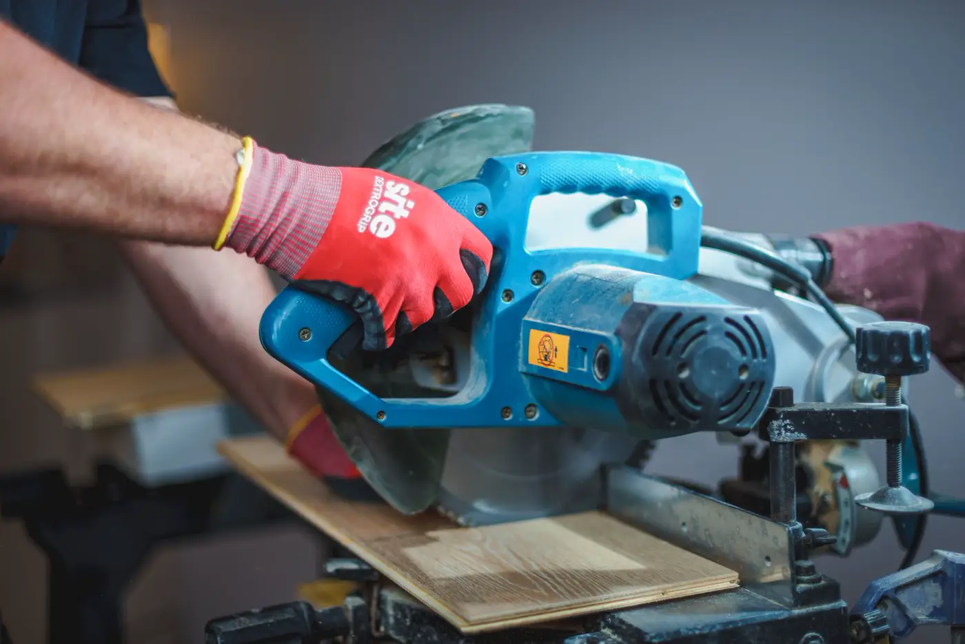 Gloved hand and saw